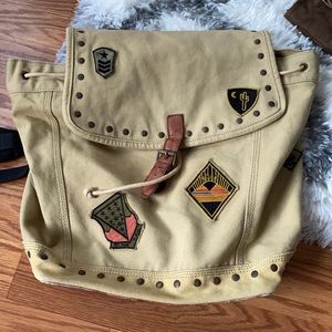 Tan draw string backpack with patches